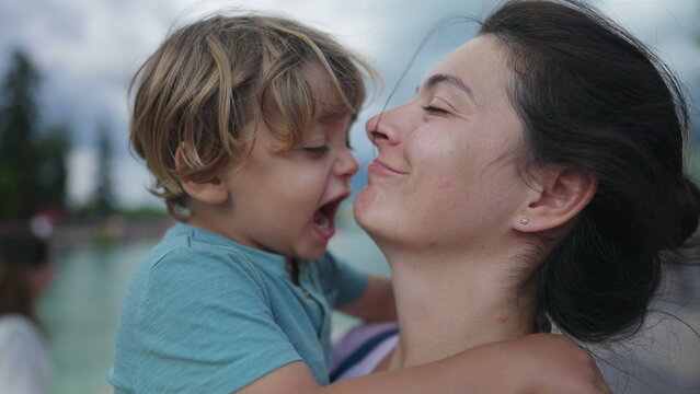 Cute mother and child bonding moment. Loving caring parent and child embrace. Lifestyle parenting hug and love outdoors