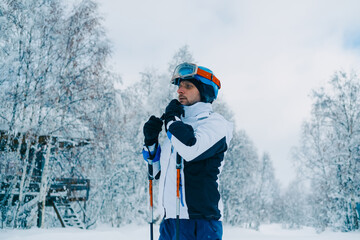 Fototapeta na wymiar Portrait of skier on snow day preparing for skiing in beautiful winter landscape