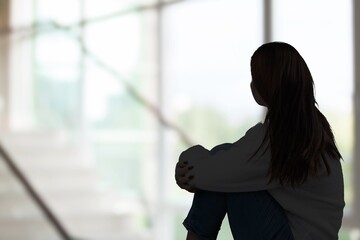 Silhouette of woman in sad mood, crying alone