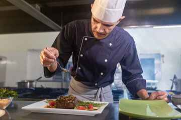 chef finishing a dish for the customer.