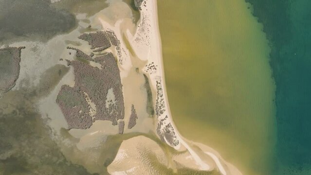 Aerial shot of a lagoon behind a beach