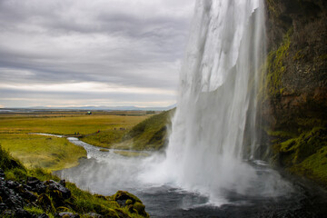 Fototapeta premium Seljalandsfoss Iceland is a stunning waterfall that allows visitors to walk behind the cascading water.