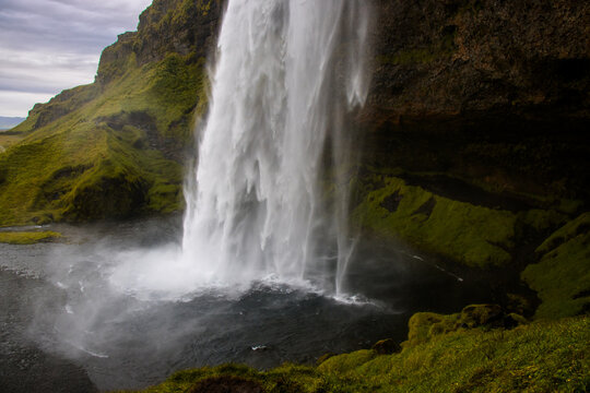 Seljalandsfoss Iceland is a stunning waterfall that allows visitors to walk behind the cascading water. © Jasper Neupane