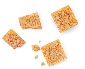 Pieces of cane sugar isolate on white background. Thatched brown sugar cube set Top view. Flat lay.