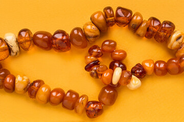Amber beads on yellow