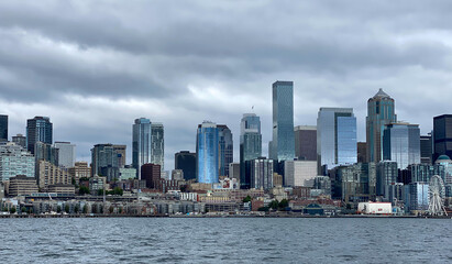 Fototapeta na wymiar City of Seattle skyline, with sun reflecting on buildings, as seen from a boat on Elliott Bay.