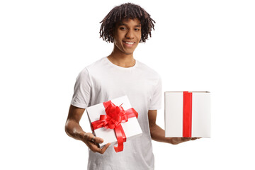 Happy young african american guy holding a gift box with red ribbon