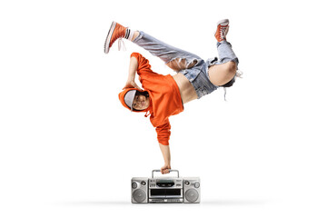 Young female performing a handstand with a boombox