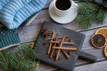Obraz na płótnie Canvas Christmas tree made of cinnamon sticks and black coffee, sweater, jeans on a wooden table.