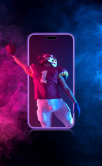 American football player. Sports betting on american football. Sportsman with ball in helmet on stadium in action. Bets in the mobile application. © Mike Orlov