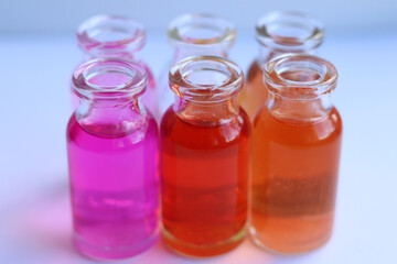Fototapeta na wymiar Glass jars with purple and red medical substances.