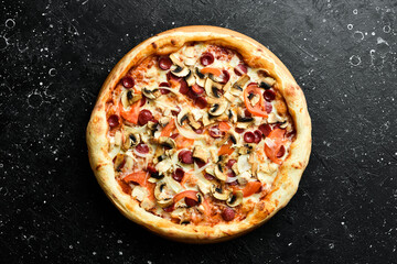 Pizza with Bavarian sausages, mushrooms and cheese. classic pizza On a black stone background. Top view.