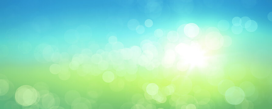 Calming fresh spring abstract background with round bokeh and sun glow. Blue and green colour computer graphic.