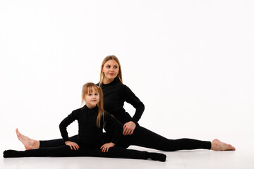 Sporty mom and her little daughter in thermal clothes.