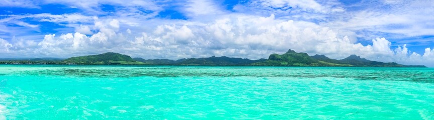 Tropical background - blue sunny sky and turquoise sea. Tropics vacation, Mauritius island, Blue bay
