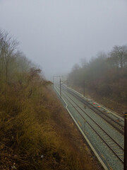 Into the Unknown: The Ambiguous Train Tracks as They Fade into the Fog
