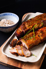 Food concept Homemade Char siu Cantonese style of barbecued pork on blackslate stone background with copy space