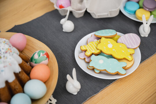 High angle view of Easter cookies and eggs near decor on table.