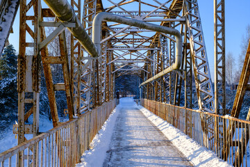 Valmiera bridge in winter. Latvian city bridge. The old railway bridge is no longer in use. Valmiera's famous tourist attraction.