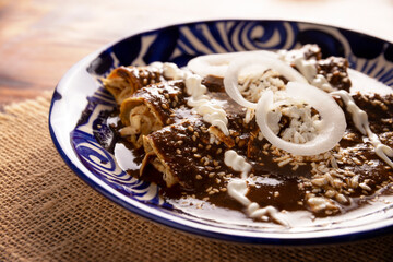 Chicken enmoladas. Also known as mole poblano enchiladas, they are a typical Mexican dish that is very popular in Mexico and the rest of the world.