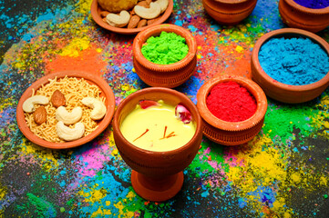 Obraz na płótnie Canvas top view of colorful traditional holi powder in bowls isolated on dark background.Space for text . happy holi.Concept Indian color festival called Holi