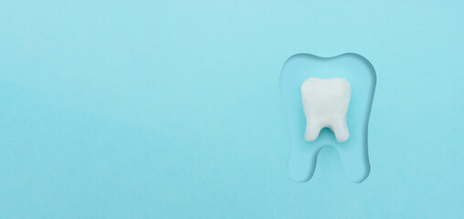 Dental care concept, Protective vortex around tooth model on blue background with copy space.