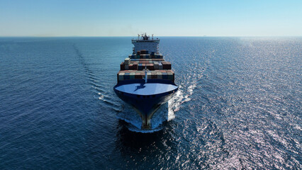 Aerial drone photo of truck size container ship cruising deep blue Mediterranean sea