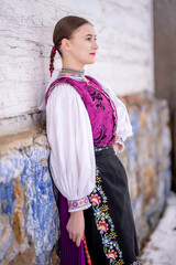 Young beautiful slovak woman in traditional costume. Slovak folklore