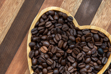 coffee beans in heart-shaped tra,y representing love of coffee