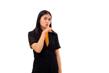 Young asian business woman standing while making silence gesture
