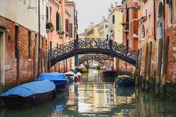 Fototapeta na wymiar Canals and gondolas in Venice, Italy, Europe. Colorful buildings and typical Venice gondolas. Venezia.