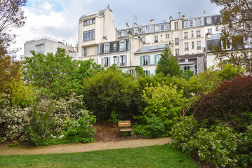 Fototapeta na wymiar Park and Traditional Parisian Apartment Buildings in Paris, France