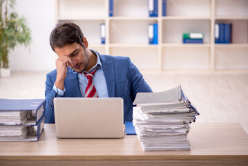 Young male employee working in the office