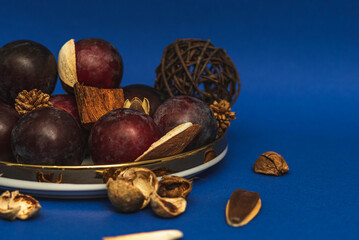 Obraz premium Juicy plums on a gold-rimmed platter. On a blue background. 