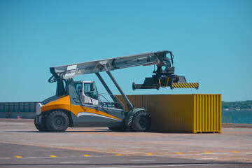 Forklift truck handling container box, loading container in the port.