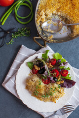 Salt cod brandade garnished with thyme. Salt cod is blended with potatoes, milk, garlic, and olive oil, then baked in a casserole or au gratin pan.