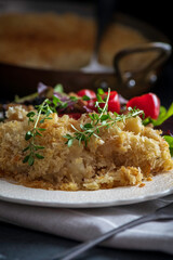 Salt cod brandade garnished with thyme. Salt cod is blended with potatoes, milk, garlic, and olive oil, then baked in a casserole or au gratin pan.