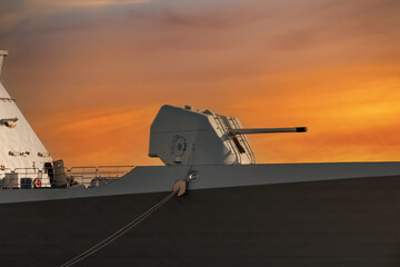 Large cannon on board an army warship, orange sky background. A gun turret on a battleship © Armands photography