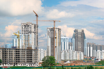 View of the construction site with multi-storey residential buildings under construction of varying degrees of completion.