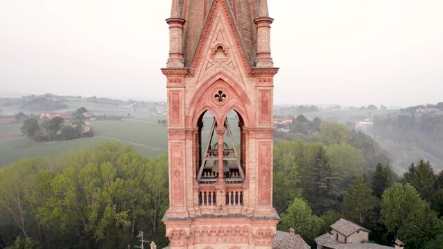 close up drone view of Castelvetro di Modena medieval bell tower in Emilia Romagna during sunrise on a cold Fall morning