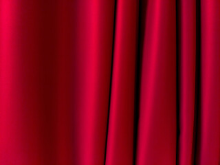 Close-up image of red curtain. Curtain draped in waves on the right side. 