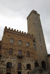 Fototapeta na wymiar Town hall and medieval tower in the ancient village of San Gimignano in the Tuscany region in Italy