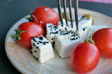  greek feta cubes with tomato diced soft cheese on plate 