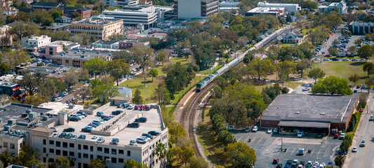 Aerial panoramic view of downtown Winter Park, Florida. USA February 22, 2023. Train visible on...