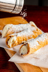 Cannoli. Classic traditional Italian dessert. Italian pastries made with tube-shaped shells of fried pastry dough filled with a sweet, creamy ricotta filling. Traditional Sicilian dessert.