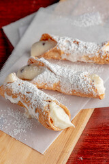 Cannoli. Classic traditional Italian dessert. Italian pastries made with tube-shaped shells of fried pastry dough filled with a sweet, creamy ricotta filling. Traditional Sicilian dessert.