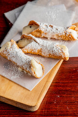 Cannoli. Classic traditional Italian dessert. Italian pastries made with tube-shaped shells of fried pastry dough filled with a sweet, creamy ricotta filling. Traditional Sicilian dessert.