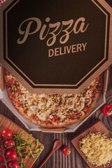 Brazilian pizza with mozzarella, pea, bacon and champignons mushrrom in a delivery box (Pizza especial) - Top view.