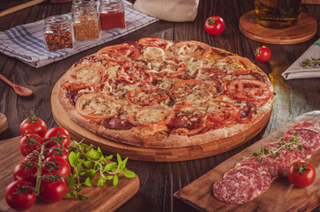 Brazilian pizza with mozzarella, salami, tomato and parmesan cheese(Pizza de salame com parmesao)
