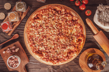 Brazilian pizza with tomato sauce, mozzarella, bacon and oregano (Pizza de bacon) - Top view.